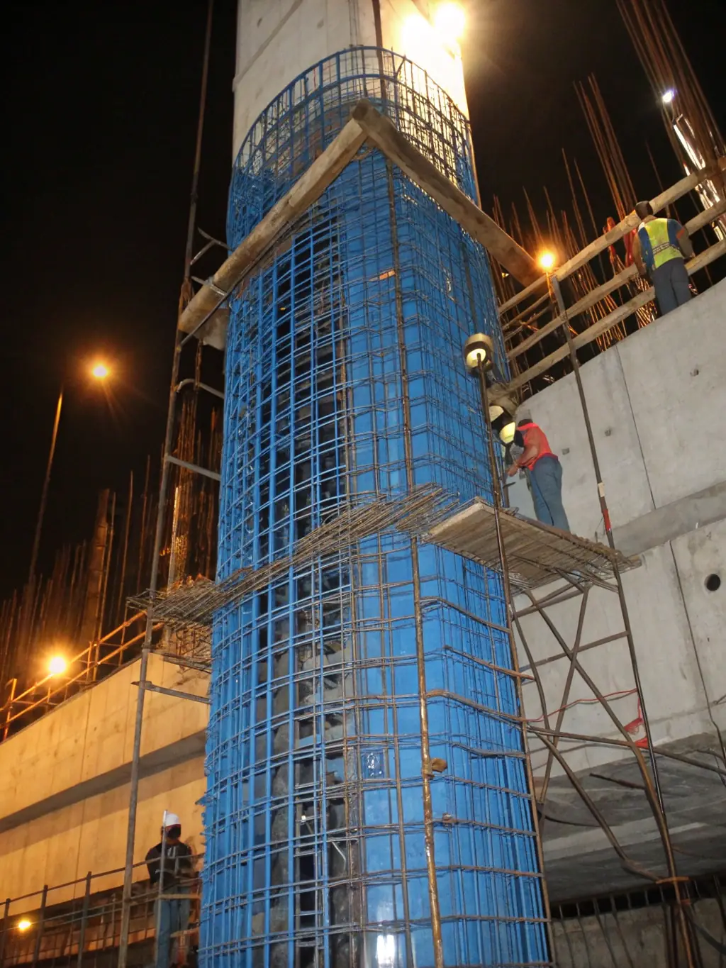 An image of a steel reinforcement cage being assembled, showcasing the complexity and strength of steel reinforcement structures.